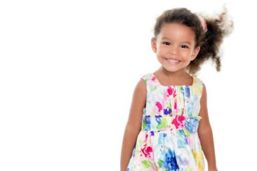Cute small girl wearing a flowers summer dress